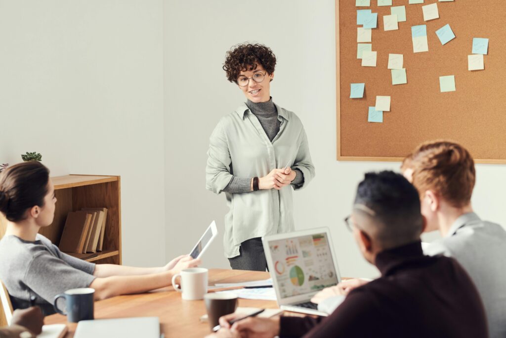 "Female leader guiding her team with confidence, showcasing leadership skills in a dynamic workplace